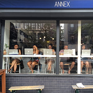 photo of people sitting front of silver MacBook thumbnail