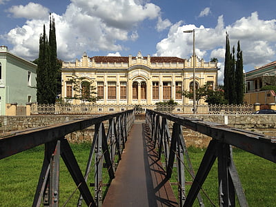 metal bridge towards beige building thumbnail