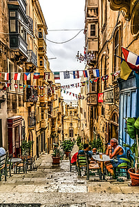 bunting of flags hanging between buildings thumbnail
