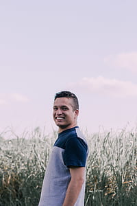 man standing in front of grass thumbnail