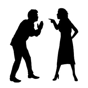 Silhouette of two people arguing. thumbnail