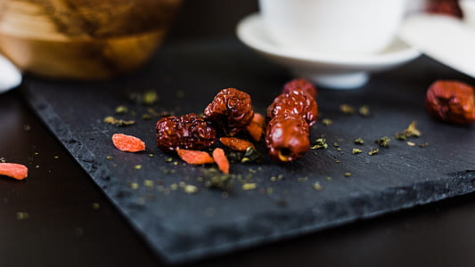 selective focus photography of brown seed on black surface thumbnail
