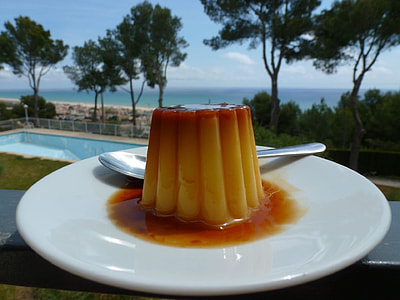 custard cake beside gray stainless steel spoon on white ceramic plate thumbnail