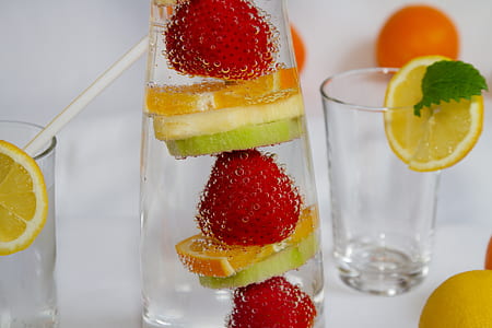 orange, strawberry, and lemon juice with drinking glasses thumbnail