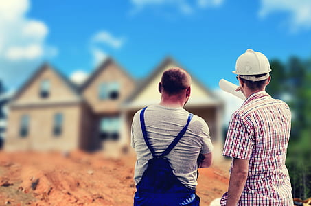 two person facing brown wooden building during daytime thumbnail