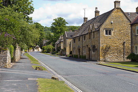 grey asphalt road beside brown concrete house thumbnail