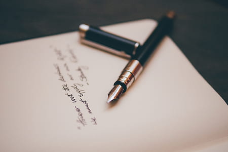 fountain pen on white book thumbnail