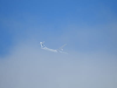 low-angle photo of airplane on clouds thumbnail