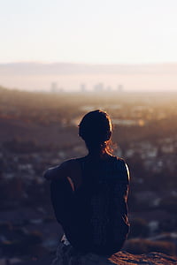 woman sitting near mountain thumbnail