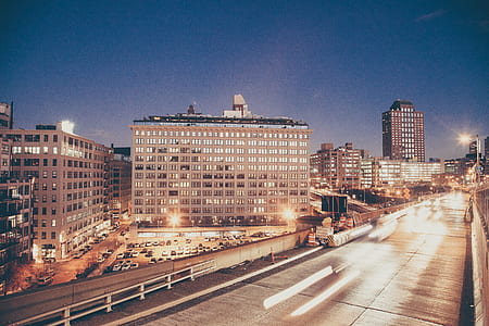 eye level photo of concrete high-rise buildings with glass walls during nighttime thumbnail