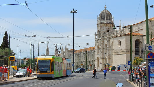 three people crossing pedestrian lane near cable tram thumbnail