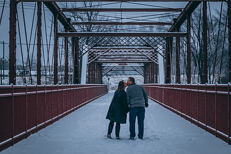 Couple Kissing on Bridge Covered With Snow thumbnail