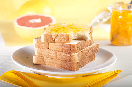slice of loaf with jam on white ceramic plate thumbnail