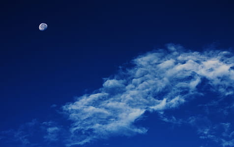 White Clouds Under Blue Sky With Gibbous Moon thumbnail