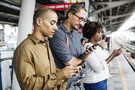 people holding their phone texting at train station thumbnail