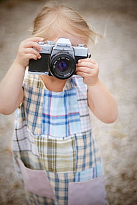 girl holding a gray Minolta camera thumbnail