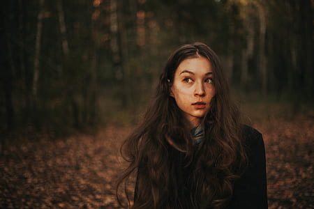 woman walking in middle of trees thumbnail