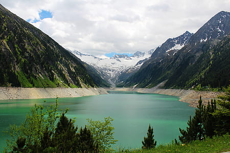 teal water in middle on two mountains during daytime thumbnail