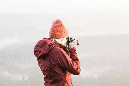 shallow focus photography of person holding DSLR camera thumbnail
