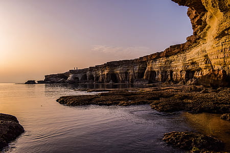 brown cliff and body of water thumbnail