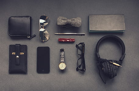 black headphones, black framed eyeglasses, black smartphone, black leather card wallet thumbnail