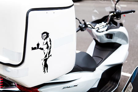 white motor scooter on parking area thumbnail