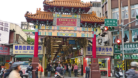 brown and red Chinese arch surrounded by people during daytime thumbnail