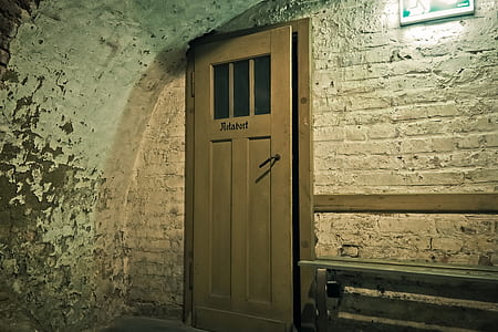 Brown Wooden Door Near White Brick Wall thumbnail