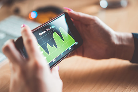 Young Woman Analyzing Website Traffic/Earnings Chart on iPhone thumbnail