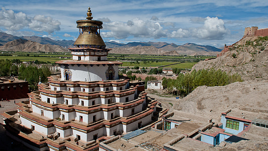 photo of brown and white 6-tier building during daytime thumbnail
