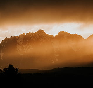 silhouette color of trees and mountain at daytime thumbnail