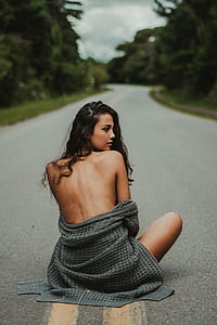 woman sitting in the middle of the road thumbnail