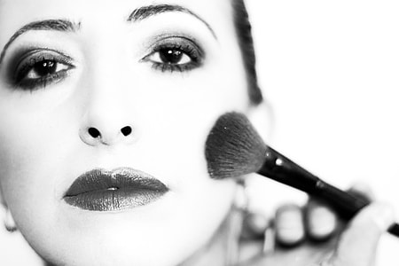 woman holding makeup brush thumbnail
