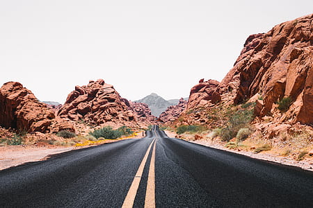 black empty road between rocks thumbnail