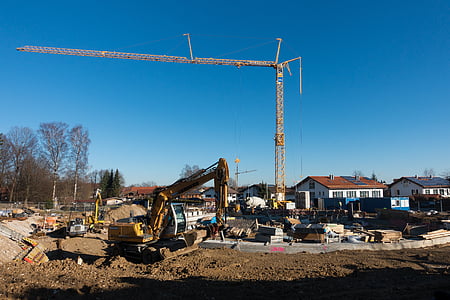 yellow excavator and construction crane at daytime thumbnail
