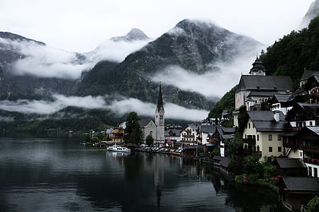 houses near body of water and mountain thumbnail
