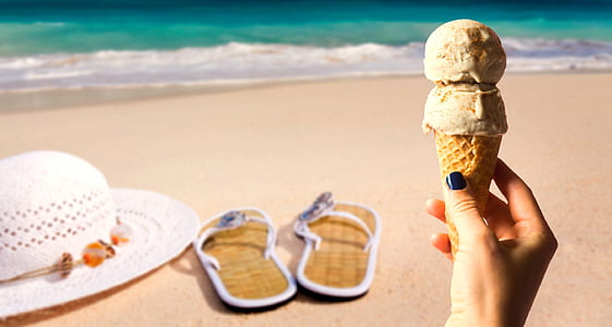 person holding ice cream in beach thumbnail