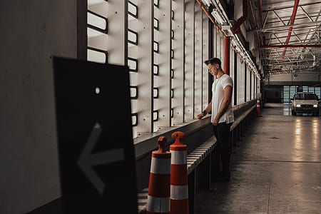 man in white shirt looking at the window thumbnail