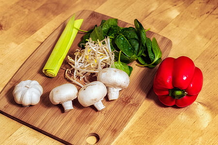 several vegetables on top of brown wooden chopping board thumbnail