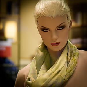 closeup photo of mannequin wearing green shawl thumbnail
