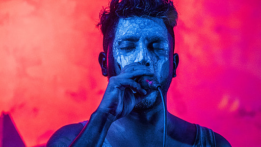 man holding microphone with red background thumbnail