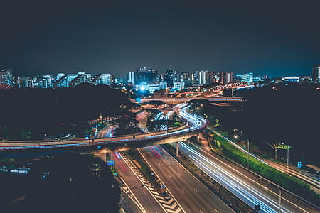 time-lapse photography of asphalt roads under night sky thumbnail