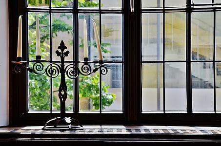 black steel candelabra near window thumbnail