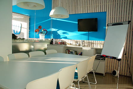 black flat screen TV on blue wooden wall thumbnail