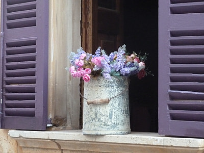 assorted flowers in steel bucket on window thumbnail