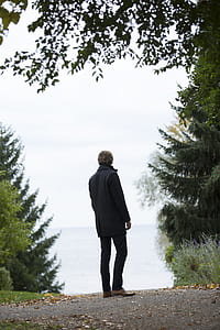 Man Standing in the Middle of Empty Road thumbnail