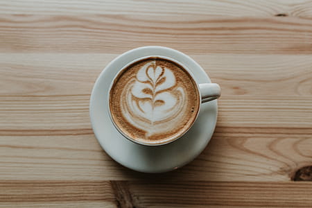Coffee in White Ceramic Teacup on White Ceramic Suacer thumbnail