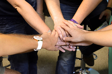 group of people doing hand sign thumbnail
