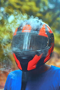 Person Wearing Orange and Black Full-face Helmet thumbnail