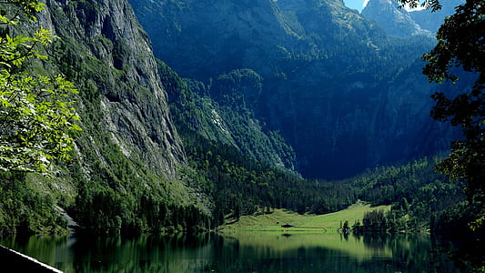 lake near mountain and trees during daytime thumbnail